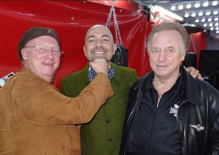 Boxbude bei Nacht mit Publikum